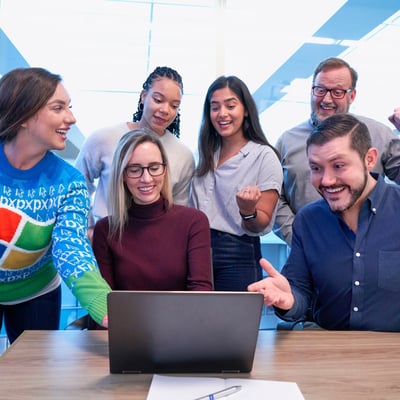 staff group around a laptop