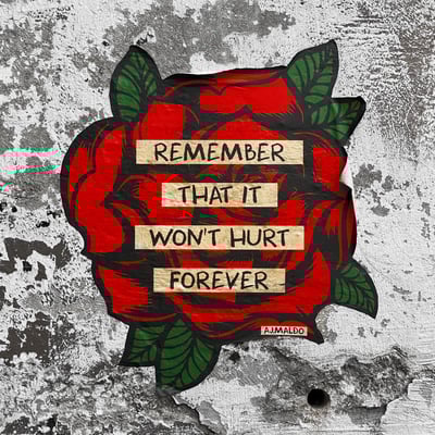 Red rose and text on concrete